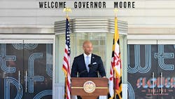 Maryland governor Wes Moore stands at a podium speaking. Maryland governor Wes Moore stands at a podium speaking.