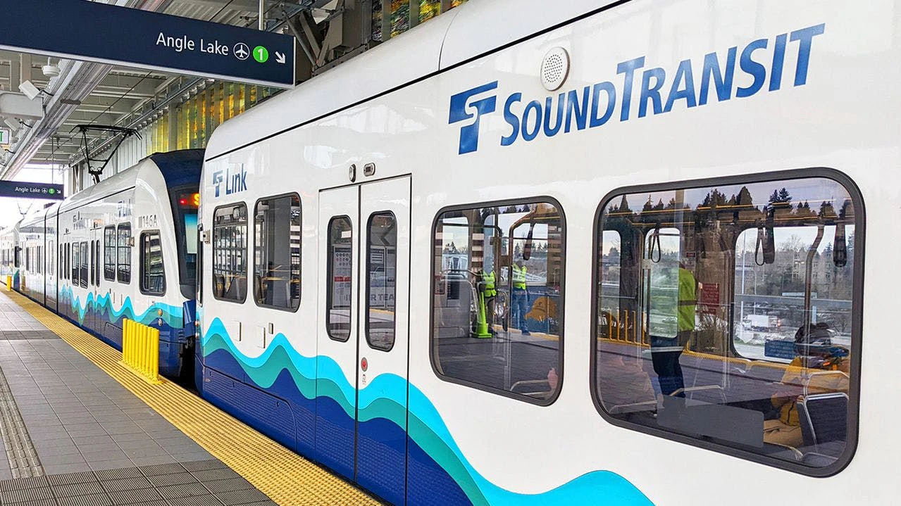 A Sound Transit rail vehicle sits at a station.