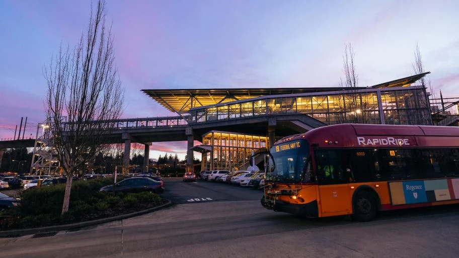 A RapidRide bus drives through dusk.