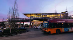 A RapidRide bus drives through dusk.