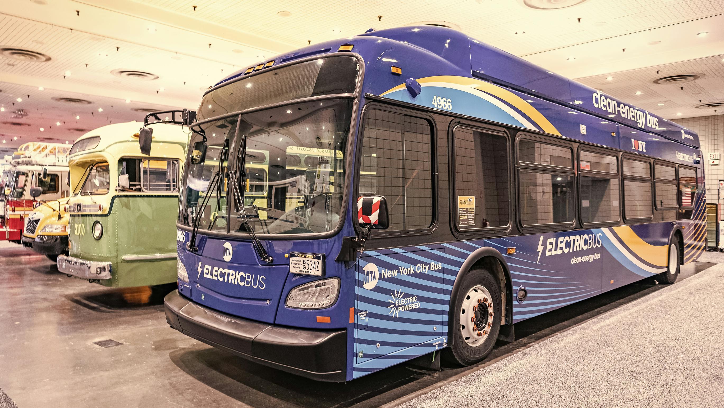 A Metropolitan Transportation Authority New Flyer Xcelsior XD60 electric bus at New York International Auto Show in a row, corner view.