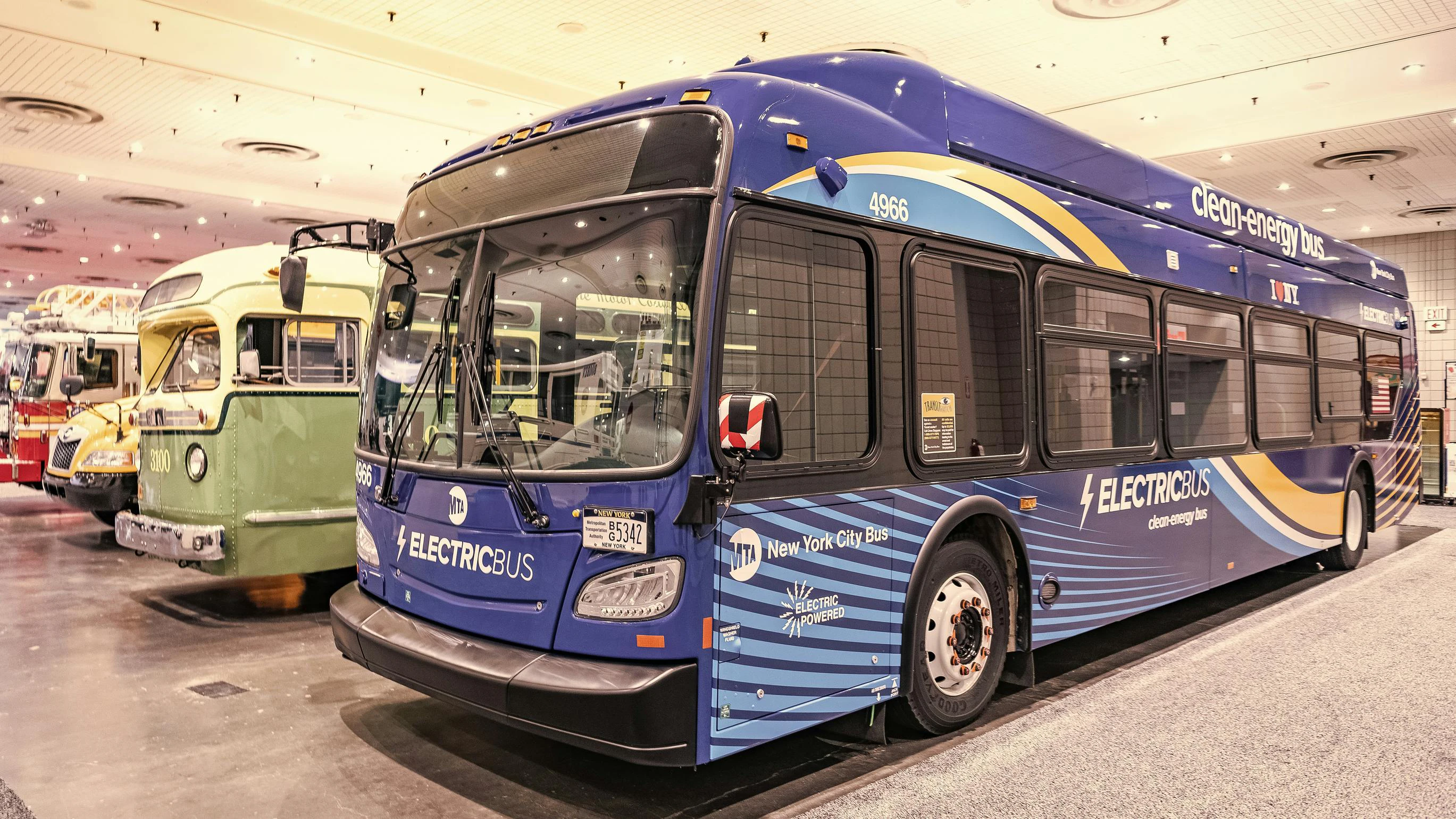 A Metropolitan Transportation Authority New Flyer Xcelsior XD60 electric bus at New York International Auto Show in a row, corner view.