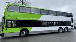 The image shows the side profile of one of the new double decker buses wrapped in green livery.