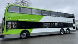 The image shows the side profile of one of the new double decker buses wrapped in green livery. The image shows the side profile of one of the new double decker buses wrapped in green livery.