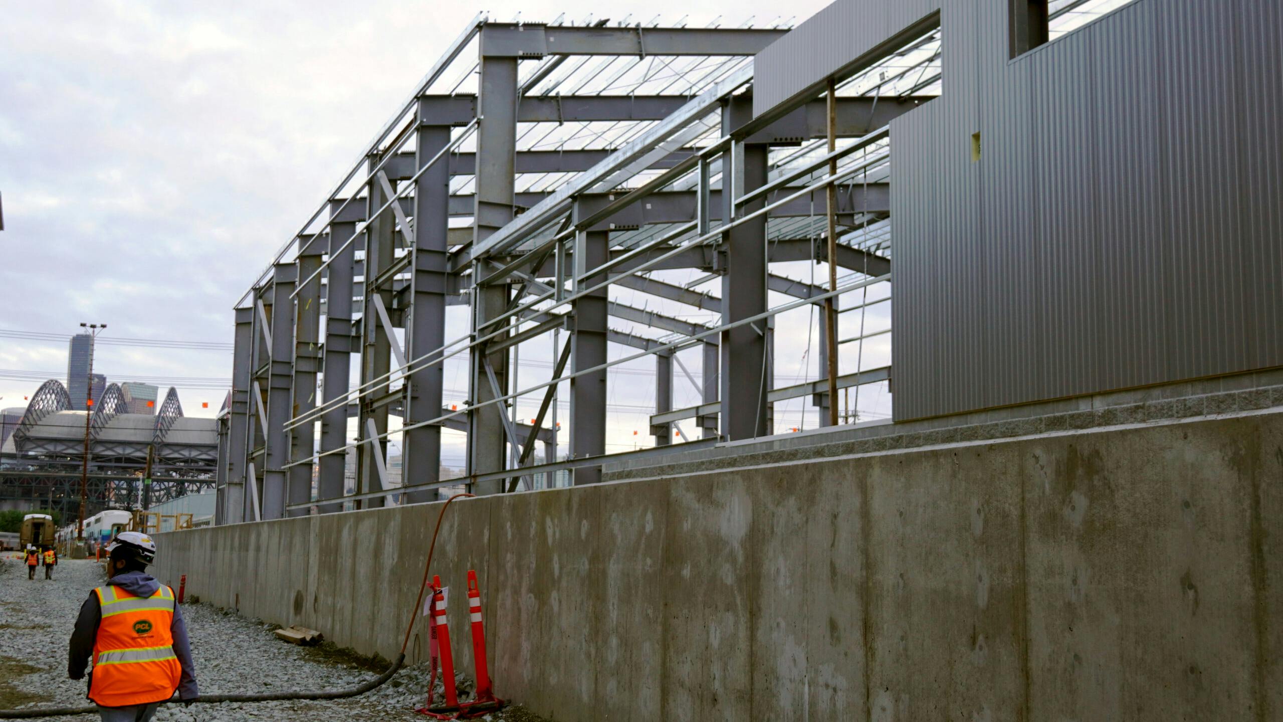 A construction worker walks alongside the new structure.