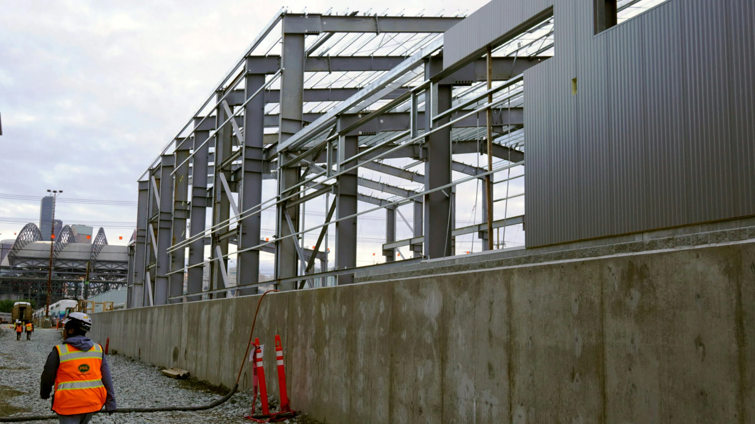 A construction worker walks alongside the new structure.