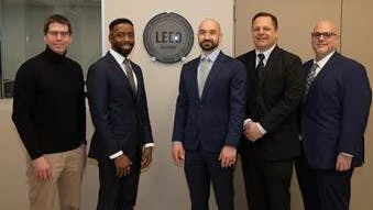 MDOT MTA leaders stand around the new LEED Silver seal.