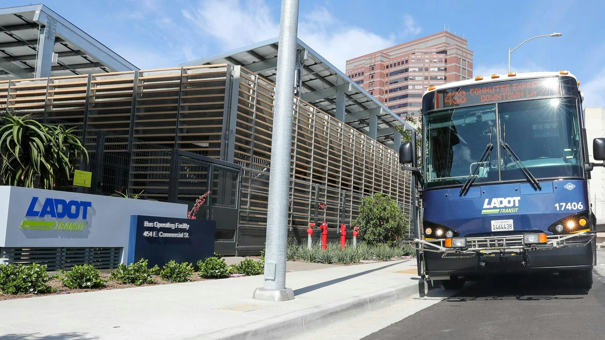 A Commuter Express bus sits next to the LADOT building.