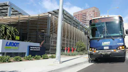 A Commuter Express bus sits next to the LADOT building. A Commuter Express bus sits next to the LADOT building.
