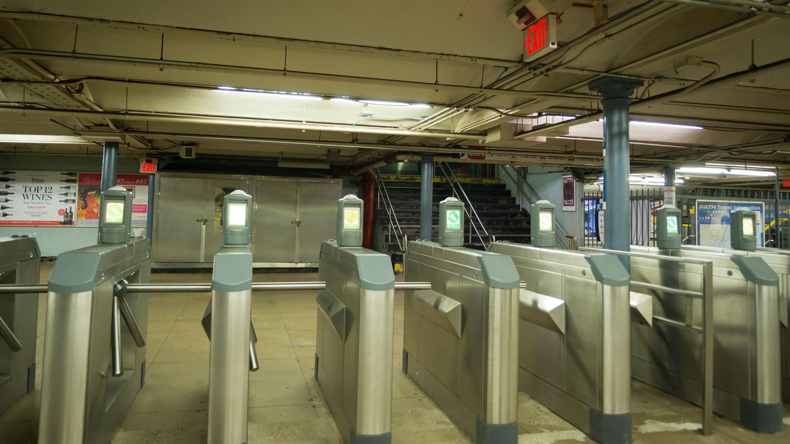 Turnstyles with no people walking in the station.