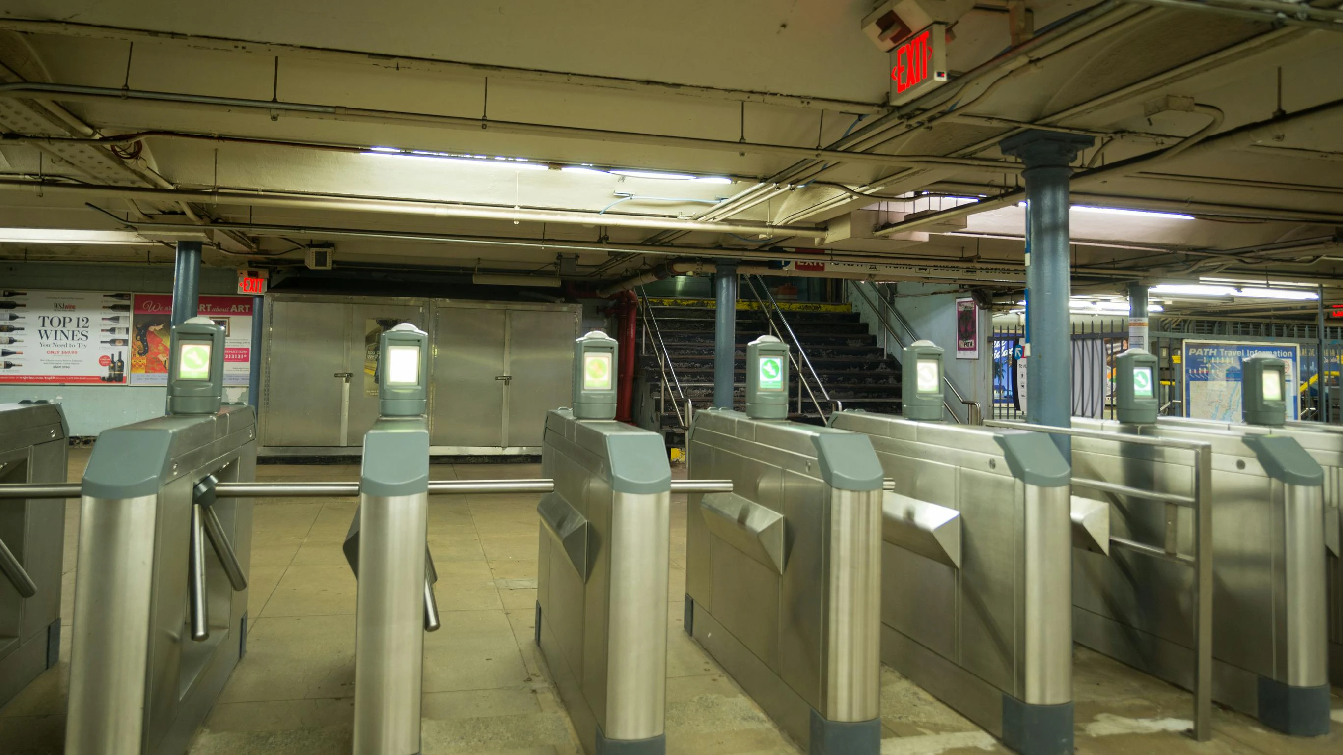 Turnstyles with no people walking in the station.