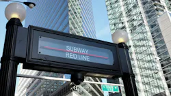 The image shows the sign for a Red Line subway station. The image shows the sign for a Red Line subway station.