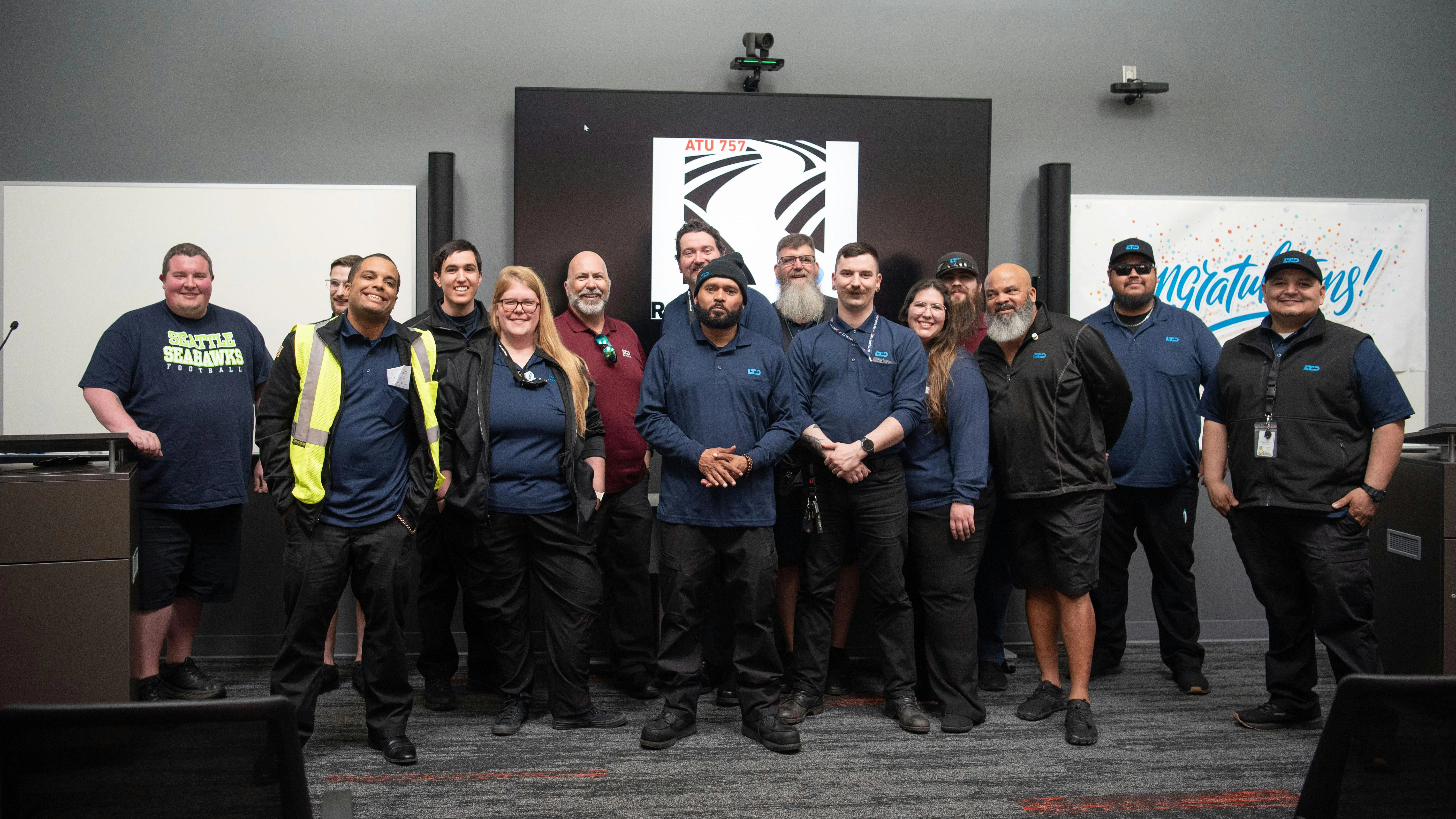 Lane Transit District's new apprenticeship class stands posed with their mentors.