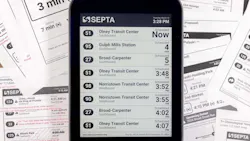The image displays an e-paper display with transit times displayed. The image displays an e-paper display with transit times displayed.