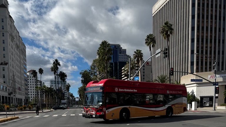 long best transit bus makes right turn on street