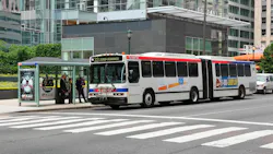 A Southeastern Pennsylvania Transportation Authority articulated bus, Route 33 to 23rd-Venango, stops at a covered bus shelter in downtown Philadelphia as passengers board. The white bus with red and blue striping carries vehicle number 7138. The Comcast Center tower is visible in the background. A Southeastern Pennsylvania Transportation Authority articulated bus, Route 33 to 23rd-Venango, stops at a covered bus shelter in downtown Philadelphia as passengers board. The white bus with red and blue striping carries vehicle number 7138. The Comcast Center tower is visible in the background.