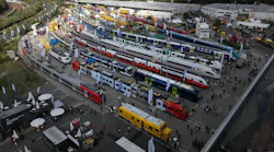 passenger trains line up outside a convention center for attendees to view