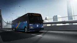 A rendered image of a Prevost motorcoach in New York City Metropolitan Transportation Authority (MTA) livery traveling across a bridge with a city skyline visible in the background. The bus features a dark blue and teal geometric livery with a yellow diagonal accent stripe and the MTA logo on the front. The destination sign reads 'M1 Harlem 147 Street Via Madison.' The vehicle number is displayed as 0000, indicating this is a manufacturer's rendering rather than a photo of an in-service vehicle. Motion blur on the road surface conveys a sense of speed. A rendered image of a Prevost motorcoach in New York City Metropolitan Transportation Authority (MTA) livery traveling across a bridge with a city skyline visible in the background. The bus features a dark blue and teal geometric livery with a yellow diagonal accent stripe and the MTA logo on the front. The destination sign reads 'M1 Harlem 147 Street Via Madison.' The vehicle number is displayed as 0000, indicating this is a manufacturer's rendering rather than a photo of an in-service vehicle. Motion blur on the road surface conveys a sense of speed.