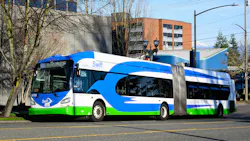 A Community Transit Swift bus rapid transit articulated bus, numbered 24706, travels along a city street in the Pacific Northwest. The bus features the Swift BRT livery of blue, white and green with a wave design. Snow-capped mountains are visible in the background under a clear blue sky. A Community Transit Swift bus rapid transit articulated bus, numbered 24706, travels along a city street in the Pacific Northwest. The bus features the Swift BRT livery of blue, white and green with a wave design. Snow-capped mountains are visible in the background under a clear blue sky.