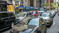 A New York City Transit bus and several cars sit in gridlocked traffic on Madison Avenue in Midtown Manhattan, with luxury storefronts including Fendi visible along the sidewalk. A New York City Transit bus and several cars sit in gridlocked traffic on Madison Avenue in Midtown Manhattan, with luxury storefronts including Fendi visible along the sidewalk.