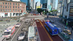 10:39 AMClaude responded: A rendering of a proposed street redesign at the intersection of Flatbush Avenue and Fourth Avenue in Brooklyn, New York.A rendering of a proposed street redesign at the intersection of Flatbush Avenue and Fourth Avenue in Brooklyn, New York. Two center lanes are designated as bus-only and marked in dark red with 'BUS ONLY' text painted on the pavement. A blue New York City Transit bus travels in one of the bus lanes heading toward the camera. Mixed traffic, including a police vehicle and an ambulance, occupies the outer lanes on either side. A glass-enclosed subway entrance structure sits in a pedestrian island in the center of the intersection. Bollards line the edges of the bus lanes. Pedestrians fill the sidewalks and crosswalks. A green-painted bike lane is visible along the left sidewalk. The surrounding urban streetscape includes a mix of low-rise commercial buildings and modern high-rise towers. 10:39 AMClaude responded: A rendering of a proposed street redesign at the intersection of Flatbush Avenue and Fourth Avenue in Brooklyn, New York.A rendering of a proposed street redesign at the intersection of Flatbush Avenue and Fourth Avenue in Brooklyn, New York. Two center lanes are designated as bus-only and marked in dark red with 'BUS ONLY' text painted on the pavement. A blue New York City Transit bus travels in one of the bus lanes heading toward the camera. Mixed traffic, including a police vehicle and an ambulance, occupies the outer lanes on either side. A glass-enclosed subway entrance structure sits in a pedestrian island in the center of the intersection. Bollards line the edges of the bus lanes. Pedestrians fill the sidewalks and crosswalks. A green-painted bike lane is visible along the left sidewalk. The surrounding urban streetscape includes a mix of low-rise commercial buildings and modern high-rise towers.