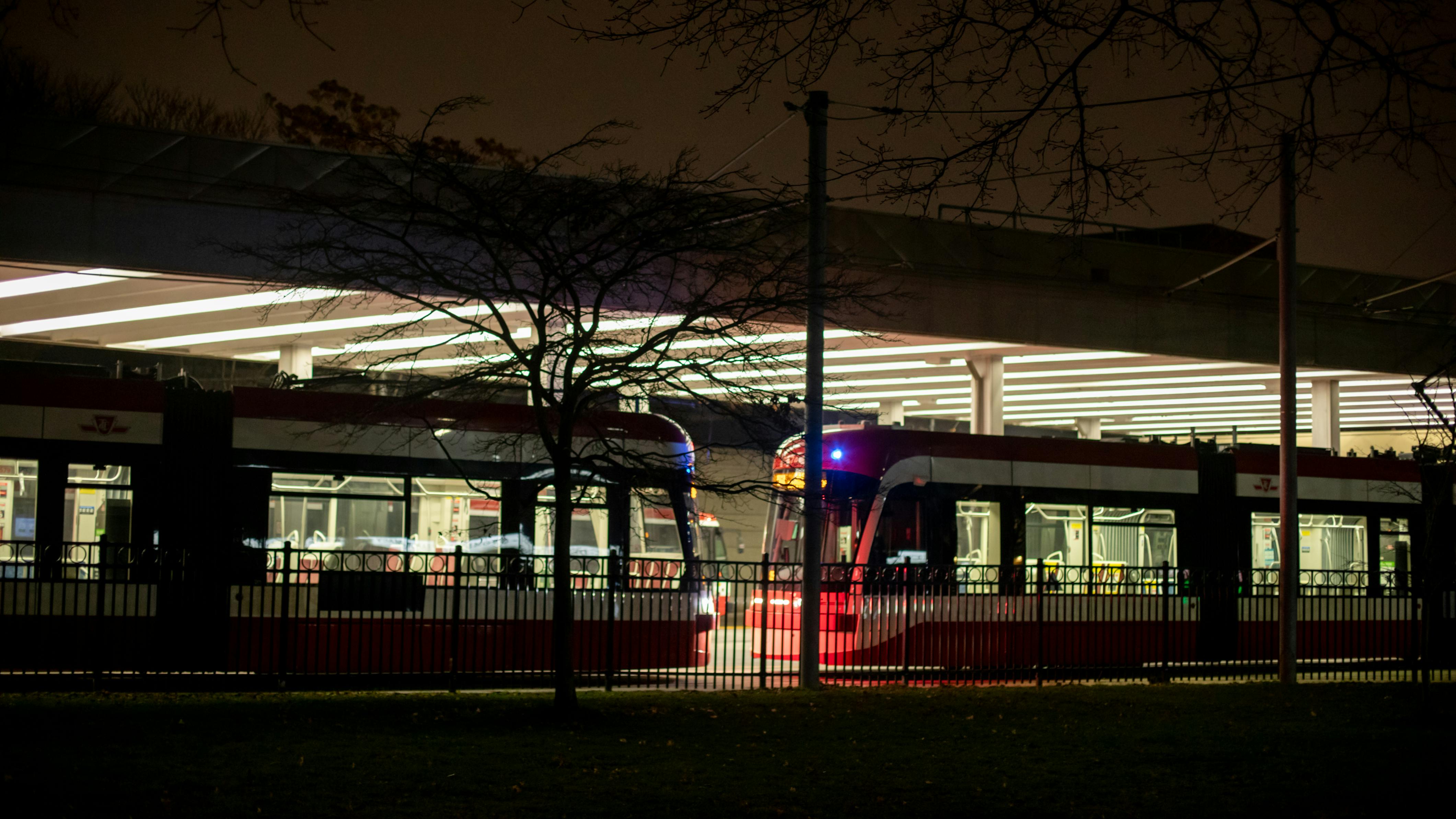 The image shows the Bathurst station illuminated at night with trains sitting in wait.