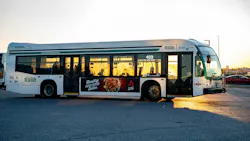 A Durham Region Transit bus, fleet number 6147, is photographed in a parking lot at golden hour. The white and green bus displays route number 403 and carries a side advertisement for Poulet Rouge restaurant. The bus faces right with its front door open, warm sunset light reflecting off the windows. A Durham Region Transit bus, fleet number 6147, is photographed in a parking lot at golden hour. The white and green bus displays route number 403 and carries a side advertisement for Poulet Rouge restaurant. The bus faces right with its front door open, warm sunset light reflecting off the windows.