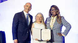 LIT Chair Eugenio Bonet, WTS International Chair Bridgette Beato and WTS International CEO Malika Reed Wilkins pose on stage holding an open signed memorandum of understanding between the two organizations. LIT Chair Eugenio Bonet, WTS International Chair Bridgette Beato and WTS International CEO Malika Reed Wilkins pose on stage holding an open signed memorandum of understanding between the two organizations.