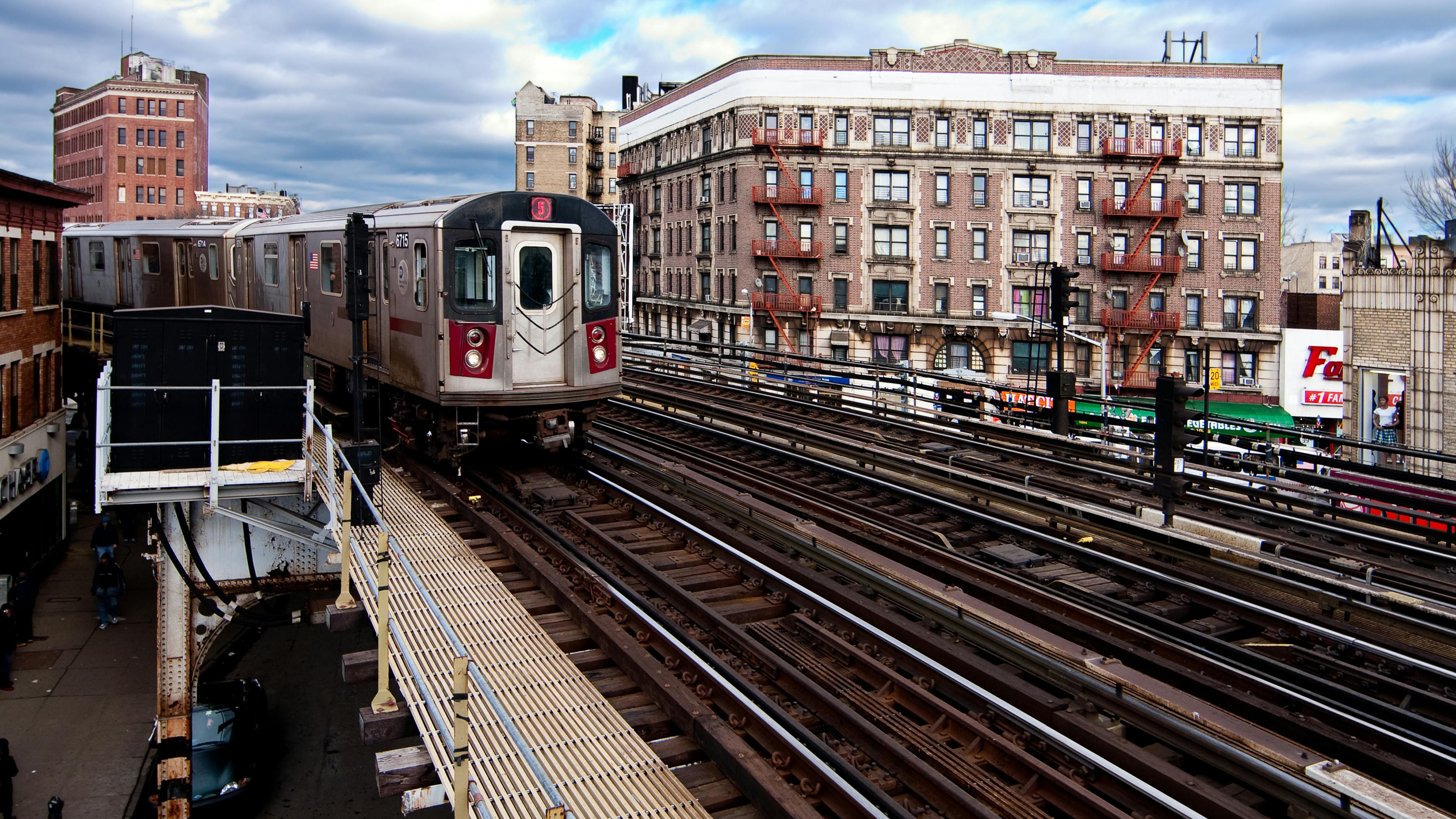 The MTA 5 Green subway line in New York City riding the rail tracks above ground in The Bronx.