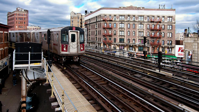 The MTA 5 Green subway line in New York City riding the rail tracks above ground in The Bronx.