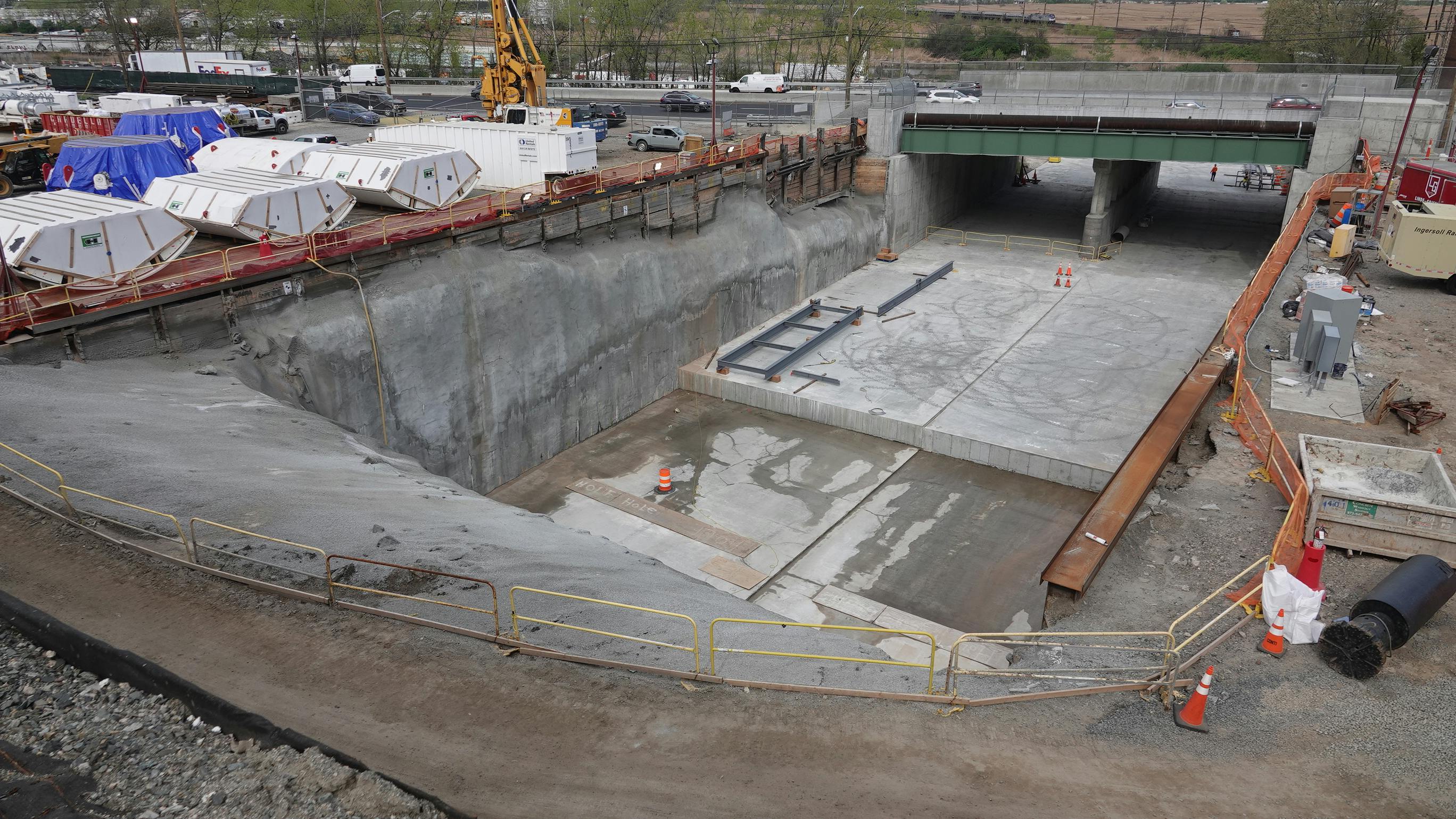Tunnel boring machine components next to the launch box at the Palisades Portal construction site.