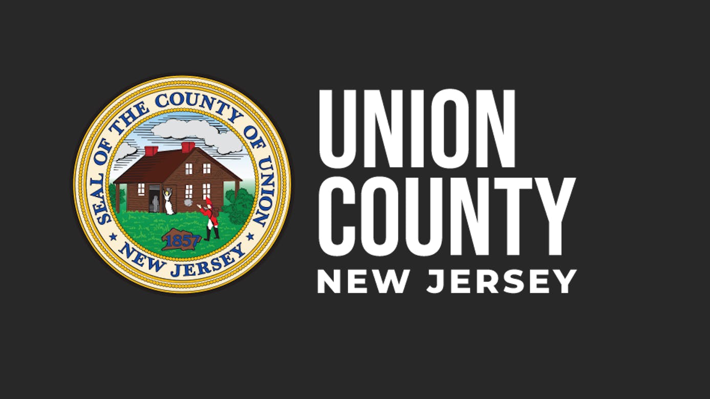 The Union County, New Jersey logo, featuring the county's gold-bordered circular seal depicting a colonial house and Revolutionary War scene dated 1857, alongside 'Union County New Jersey' in white text on a dark gray background.