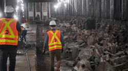 MTA construction workers examine construction progress in the new tunnel.