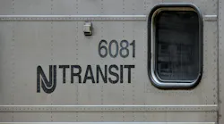 New Jersey Transit logo next to window on a commuter train car numbered 6081.