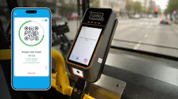 mobile phone with valid ticketing on screen to the left of the fare validator box on a bus