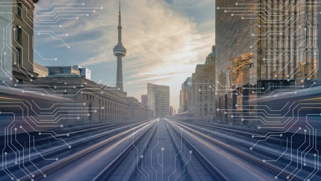 A promotional graphic for Hitachi Rail's TTC Line 2 project, featuring a perspective view down subway tracks toward the Toronto skyline with the CN Tower centered in the background, overlaid with white digital circuit board patterns symbolizing advanced rail technology and connectivity