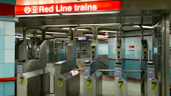 The fare gate area at a Chicago Transit Authority Red Line subway station, with a red overhead sign directing riders to Red Line trains and rows of turnstile-style fare gates equipped with contactless payment readers accepting Ventra, Apple Pay and Google Pay.