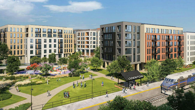 A Maryland Department of Transportation preliminary rendering of a transit-oriented development at Odenton MARC Station, depicting several mid-rise mixed-use residential buildings surrounding a landscaped green space with walking paths, a playground, and pedestrians, with a MARC commuter rail train visible at the station platform in the foreground.