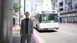 Matt Horton, AICP, stands in front of an MTS bus wearing professional clothing. The bus marquee reads 'Go Padres!'