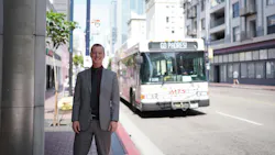 Matt Horton, AICP, stands in front of an MTS bus wearing professional clothing. The bus marquee reads 'Go Padres!'