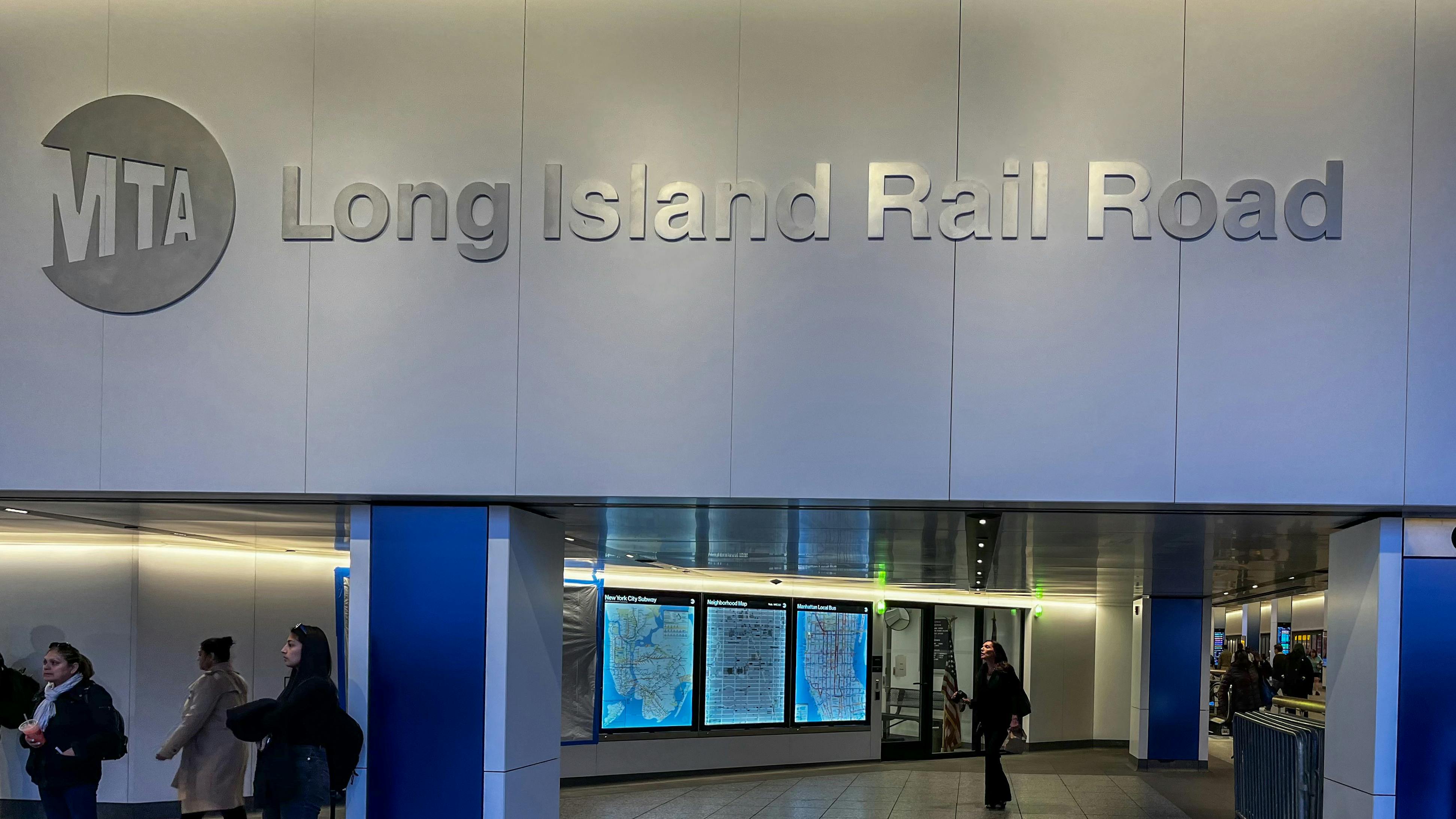 The MTA LIRR logo appears on a wall above arrivals displays.