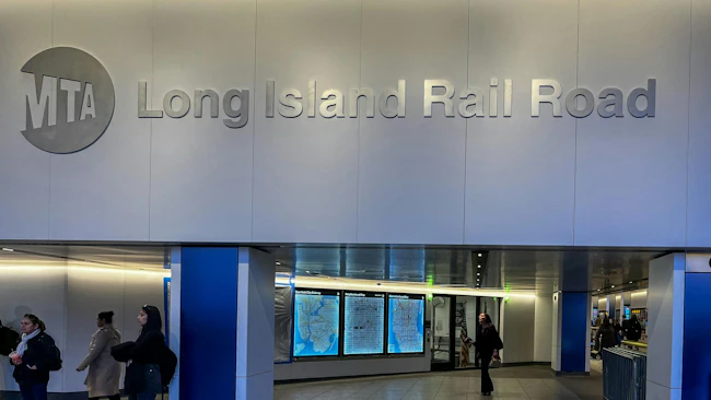 The MTA LIRR logo appears on a wall above arrivals displays.