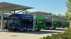 A row of Paces buses sit at the Joilet Transit Center under canopies.