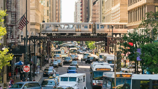 Traffic in downtown Chicago with people, train, car and bus