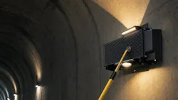A lighting fixture illuminates a tunnel, activated by a magnet post.