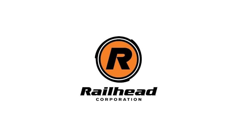 The Railhead Corporation logo, featuring a bold black 'R' centered within an orange circle and double black ring, above the company name 'Railhead Corporation' in black italic and spaced capital lettering