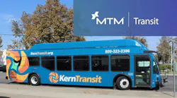 A blue Kern Transit bus parked on a street, featuring a colorful abstract wrap design, the agency's logo and website, and a promotional MTM Transit banner overlaid in the upper right corner.