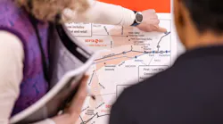 Close-up of two people examining a SEPTA route map showing the Malvern-Great Valley Zone and surrounding communities, with one person pointing to a location near Great Valley Corporate Center.