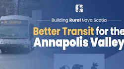 A Nova Scotia government promotional graphic reading 'Building Rural Nova Scotia — Better Transit for the Annapolis Valley,' featuring the Nova Scotia provincial logo and a background image of a transit bus numbered 59 displaying Route 2W to Coldbrook on its destination board.