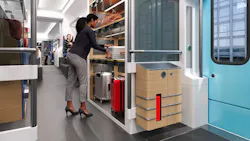 Rendering of a proposed Chicago Flyer train car interior showing an onboard luggage storage compartment, where a passenger loads a suitcase onto a shelf beside secured storage lockers and rolling bags.